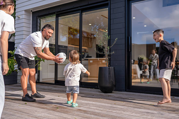 istock Father Playing Rugby With Toddler and Older Son 2218006442