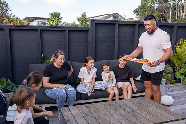 istock Family Relaxing Outdoors as Father Serves Food 2218006799
