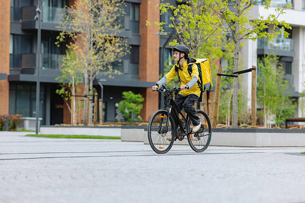 istock Courier delivering food on a bicycle in an urban environment 2218011420