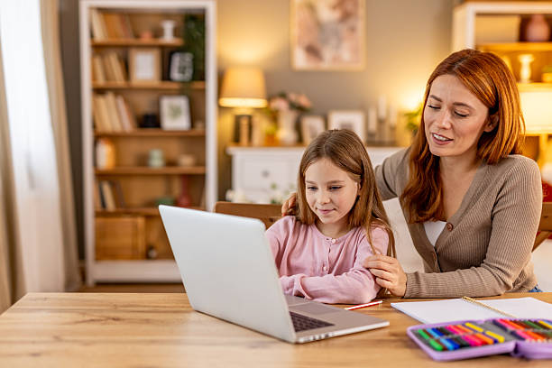 istock Mother and Daughter Studying Together at Home Using a Laptop 2218017392