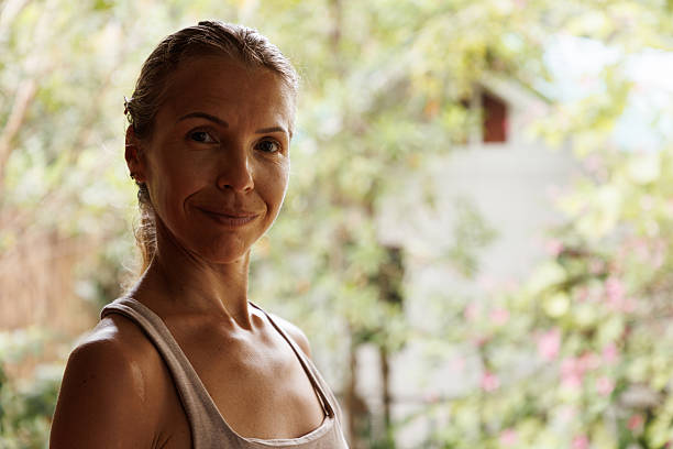 istock Smiling woman standing outdoors with blurred natural background in a summer setting 2218017478