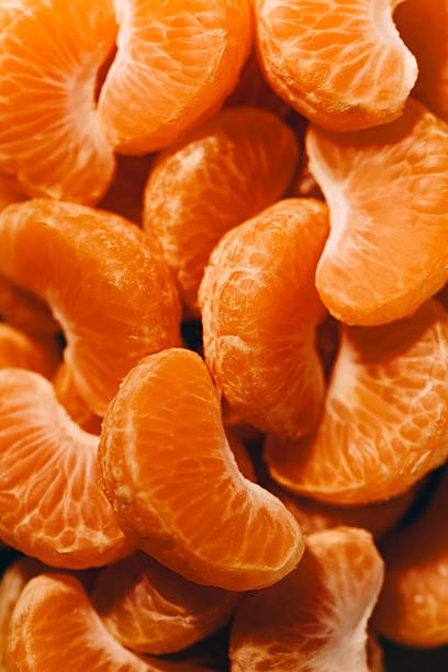 peeled tangerine slices, food background, delicious fruits, useful citrus vitamins concept, pattern, texture, selective focus