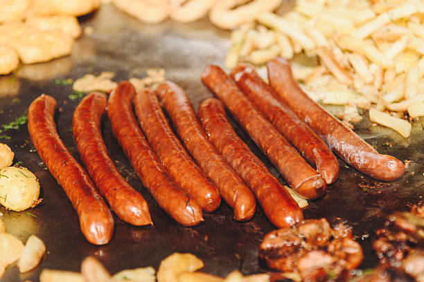 istock fried sausages in large pan outdoors 2218017558