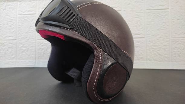 istock Modern motorcycle brown helmet with glasses 2218034887