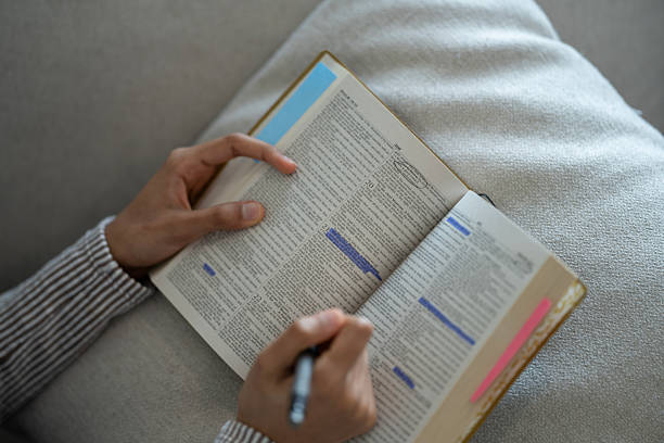 istock Person Highlighting and Studying Religious Text for Personal Growth and Reflection 2218040493