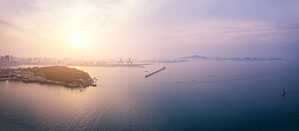 Sunrise Over Coastal Cityscape and Island