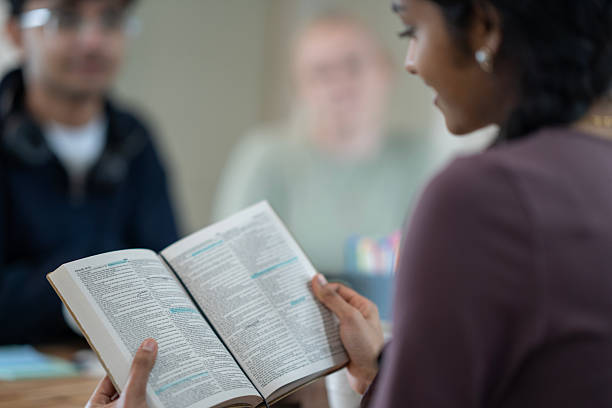istock Group Discussion on Religious Concepts Featuring a Closeup of Reading Literature 2218042193