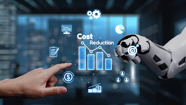 istock Robotic Arm and Human Hand Collaborating on Digital Cost Reduction Strategy in Modern Office with Graphs and Financial Icons. Auvana 2218043362