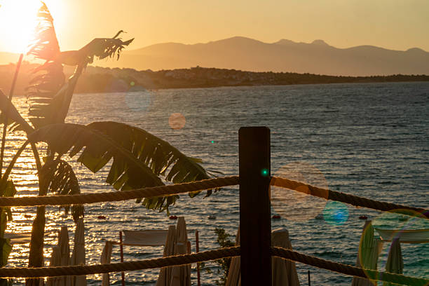 seascape at sunset with lens flare horizontal landscape still