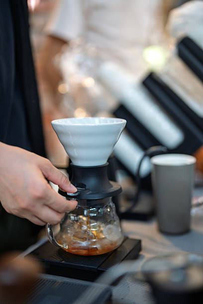 Barista Brewing Pour-Over Coffee with Ceramic Dripper and Glass Server