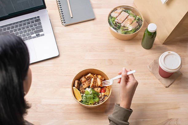 istock Businesswoman having a lunch break at the office 2218051003