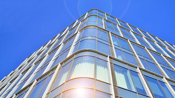 istock Modern office building with glass facade on a clear sky background. 2218051080