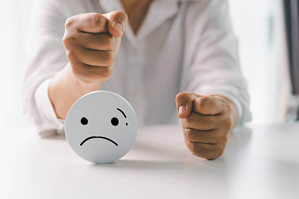 istock Close up customer hand choose sad face and blurred smiley face icon, Service rating, satisfaction concept. Negative feedback from client often reflects dissatisfaction with quality of service. 2218053168