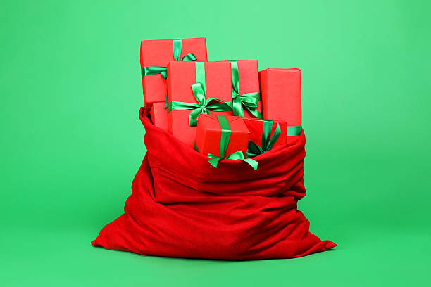 Red santa claus bag overflowing with wrapped christmas presents on a blue background. 3d rendering