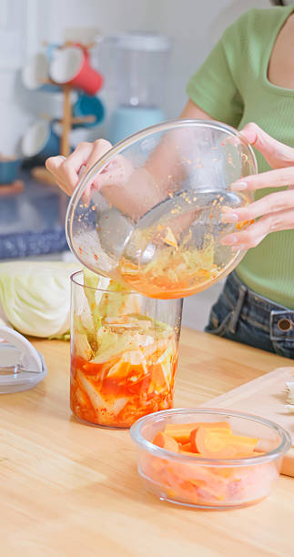 Asian Woman Storing Kimchi