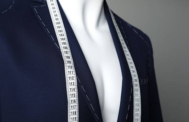 istock Semi-ready jacket with tailor's measuring tape on mannequin against grey background, closeup 2218054699