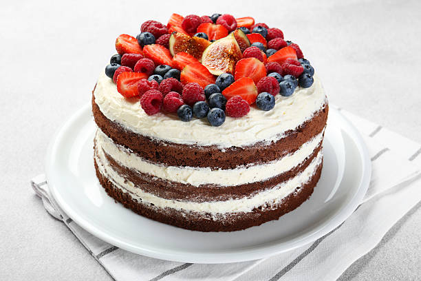 istock Delicious chocolate sponge cake with berries on light table, closeup 2218054948