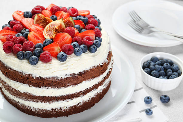 istock Delicious chocolate sponge cake with berries served on light table, closeup 2218054957