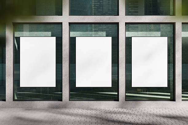 istock Modern blank posters on clean glass wall in urban setting with empty framed spaces for advertising mockup display under natural daylight reflections. 3D Rendering 2218055861