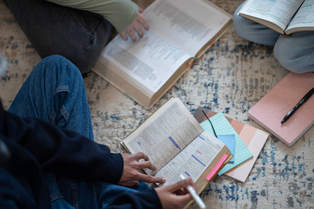 istock Group Discussion Around Open Books and Study Materials on the Floor 2218056138