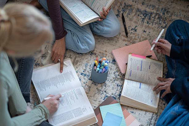 istock Group Study Session with Open Books and Colorful Marking Supplies 2218056139