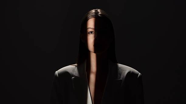 istock Portrait Photography with Dramatic Shadows and Light Beam 2218056249