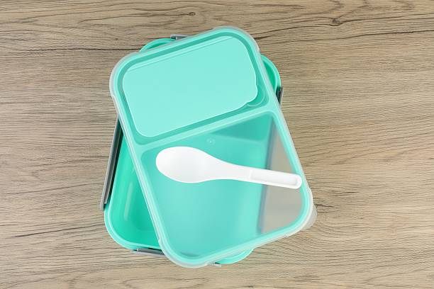 istock Empty plastic lunch box with cutlery on wooden table, top view 2218056280