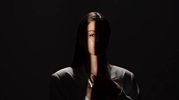istock Portrait Photography with Dramatic Shadows and Light Beam 2218056335