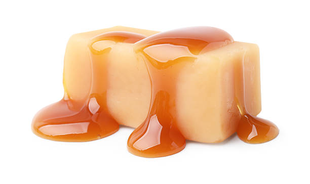 istock Tasty candy with caramel sauce isolated on white 2218056835
