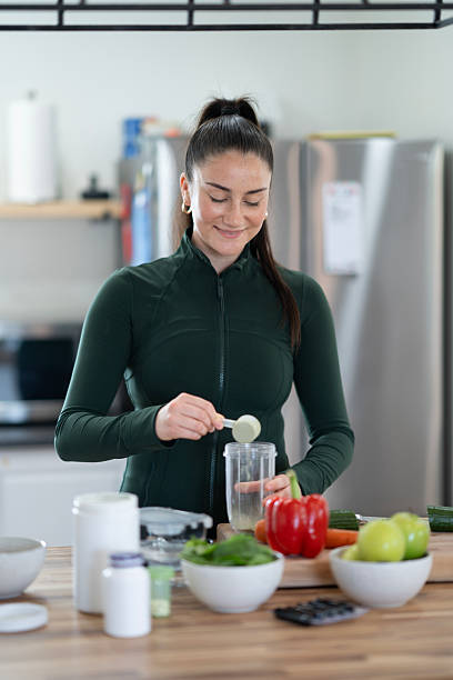 istock Woman Preparing A Healthy Smoothie With Fresh Ingredients In Modern Kitchen 2218057054
