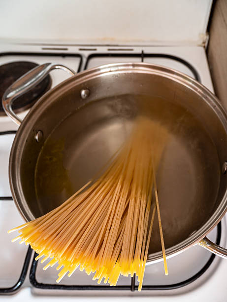 istock spaghetti is dropped into pot of boiling water 2218058036