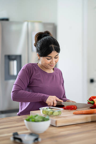 istock Woman Preparing Fresh Vegetables in Modern Kitchen for Healthy Cooking 2218058163