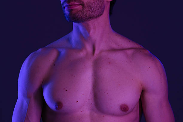 istock Artistic Lighting on Male Torso with Blue and Purple Hue 2218058903