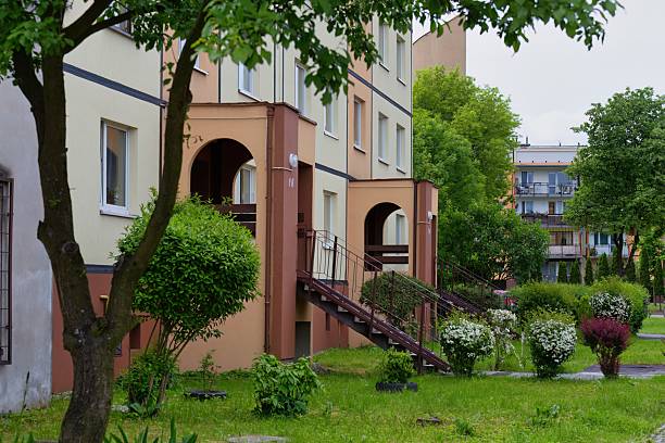 A charming, two-story building with arched entrances sits nestled among lush greenery in Sosnowiec -  Silesia - Poland