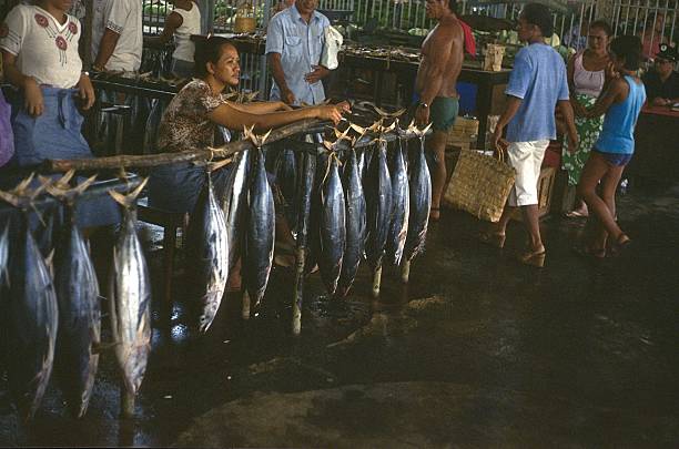 Tahiti, French Polynesia, 1982. Fish market in a Tahitian town. Also visible: fish seller and customers.