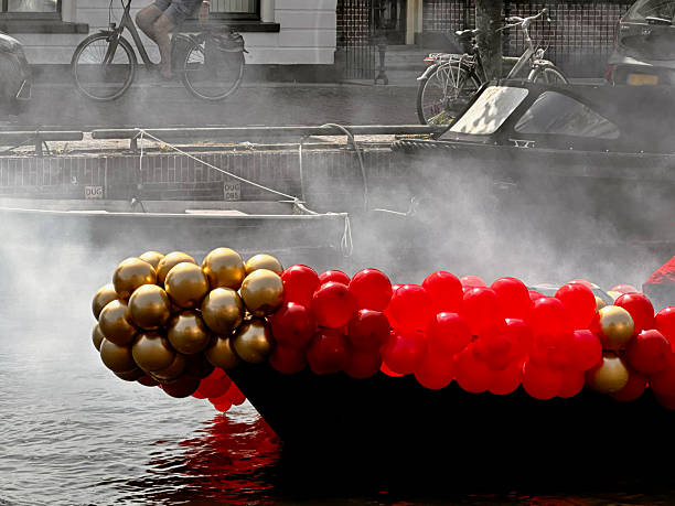 Get into the festive spirit of King's Day in Amsterdam with this vibrant background photo featuring a multitude of orange balloons or balls texture decorating the city streets. Capture the essence of this Dutch national holiday with the colorful and lively atmosphere depicted in this image.