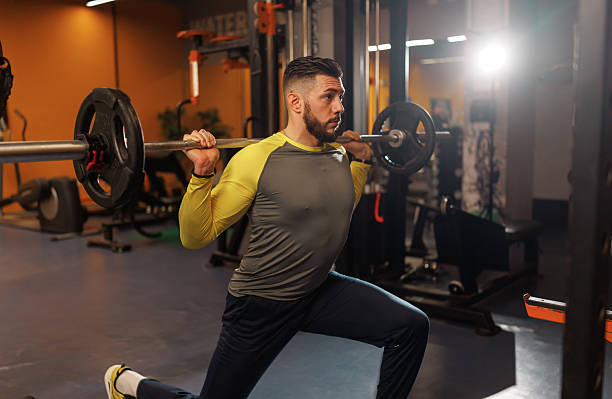 istock Handsome young man lifting weights while working out in the gym 2218064753