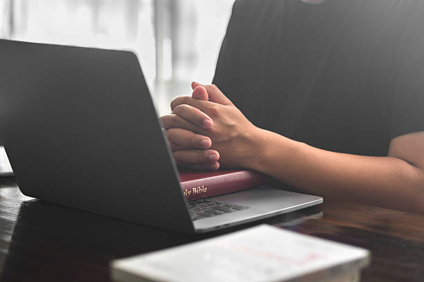 istock The concept of online prayer, online groups, online learning, trusting in God, using technology in religious applications, worshiping God at home or praying together online in remote areas. 2218064922