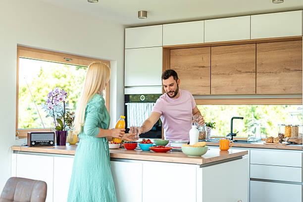 istock Young Diverse Couple Preparing Healthy Breakfast Together In Modern White Kitchen 2218065196