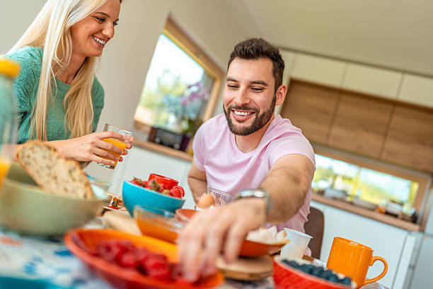 istock Young Couple Sharing Healthy Breakfast at Sunlit Kitchen Counter 2218065219