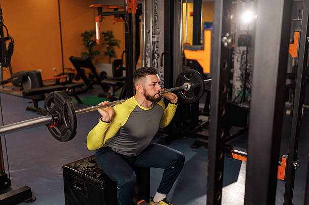 istock Handsome young man lifting weights while working out in the gym 2218065248
