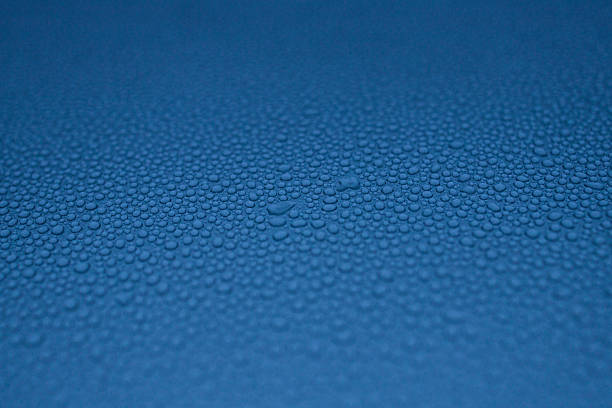 water drops on the blue metal surface, abstract background, and macro window after the rain, blue car after carwash