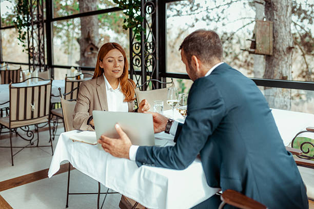 istock Business Collaboration Between Man and Woman at Formal Lunch 2218067535