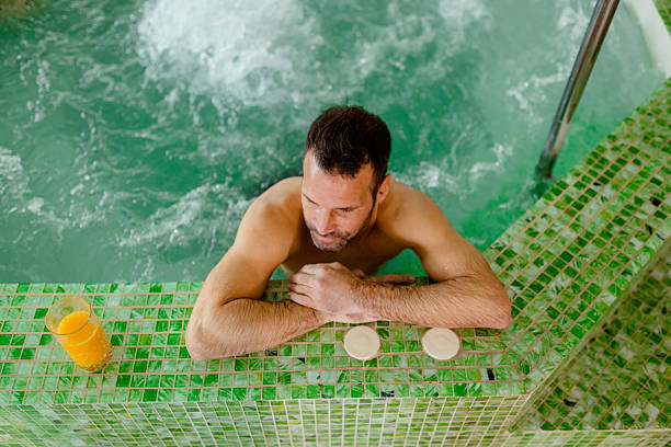 istock Wellness and Self-care Scene with Man in hot tub Setting 2218067587