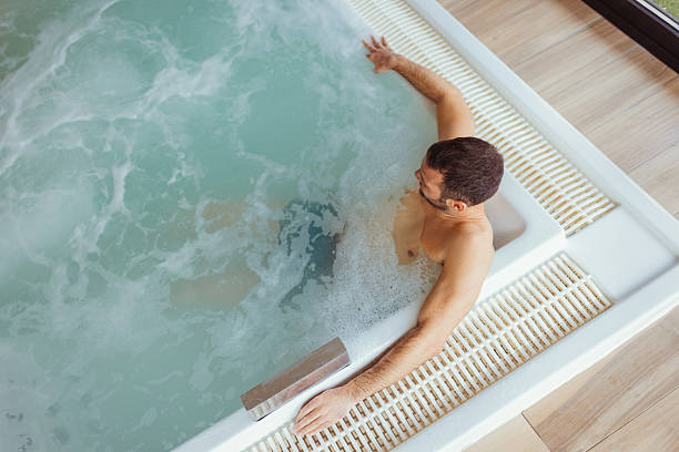 istock Man Enjoying Self-care Routine in Spa Hot Tub 2218067608