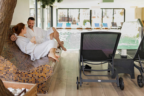 Relaxed and peaceful scene of two people enjoying thermal loungers in a high-end spa. Great for hotel and spa websites, brochures, and wellness-themed marketing.
