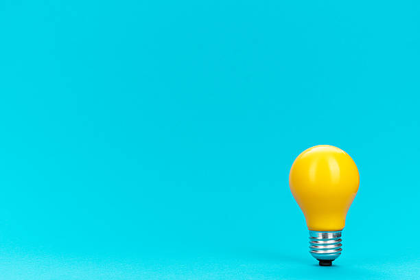 istock Minimalist photo of lightbulb over blue 2218073493