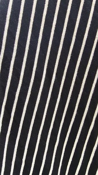 istock Close up of black knitted fabric with white stripes. 2218074319