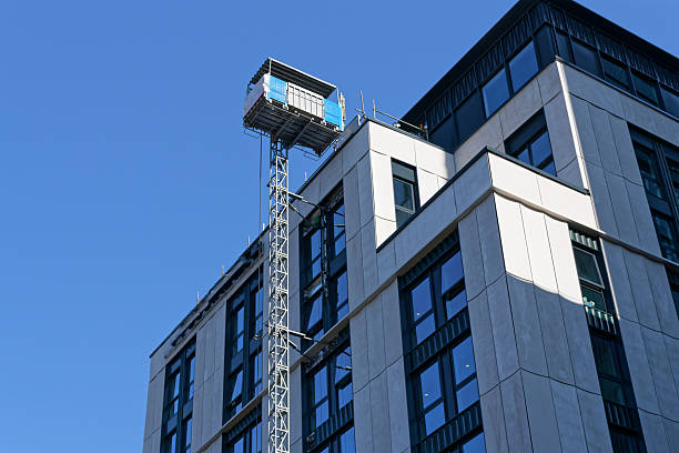 istock External lift hoist at modern high rise flats being constructed 2218075858