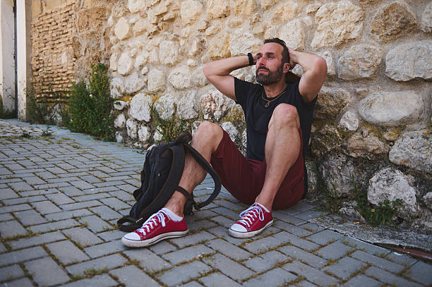 istock Traveler Resting by Ancient Stone Wall Appreciating the View 2218081386